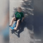 Boy with hearing loss enjoy a ride-on toy