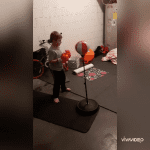 Boy with hearing loss with his toy boxing stand