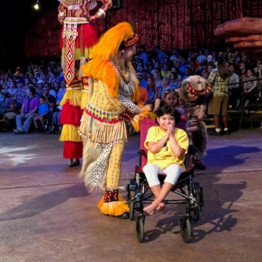 Girl in wheelchair participating in Animal Kingdom's Lion King show